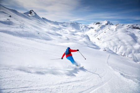 Young attractive skier skiing in famous ski resort in Alps, Livigno, Italy, Europe.